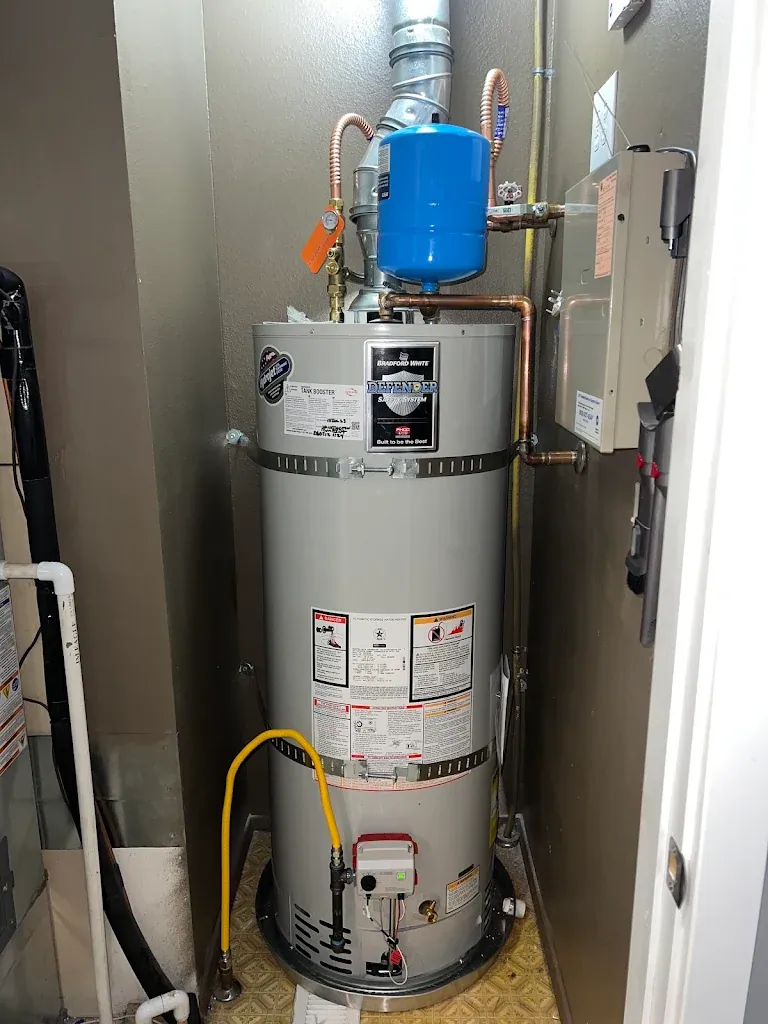 Bradford White gas water heater in a closet with expansion tank, new copper lines, seismic straps and gas flex