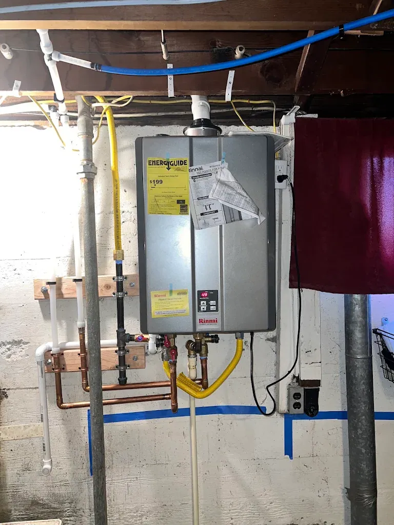 Rinnai tankless water heater installed in a basement with new copper and gas piping